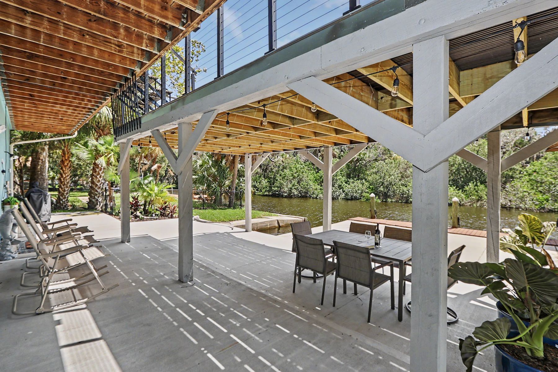 Chairs and the long concrete apron at The Rusty Hook Riverhouse, Old Homosassa, Florida