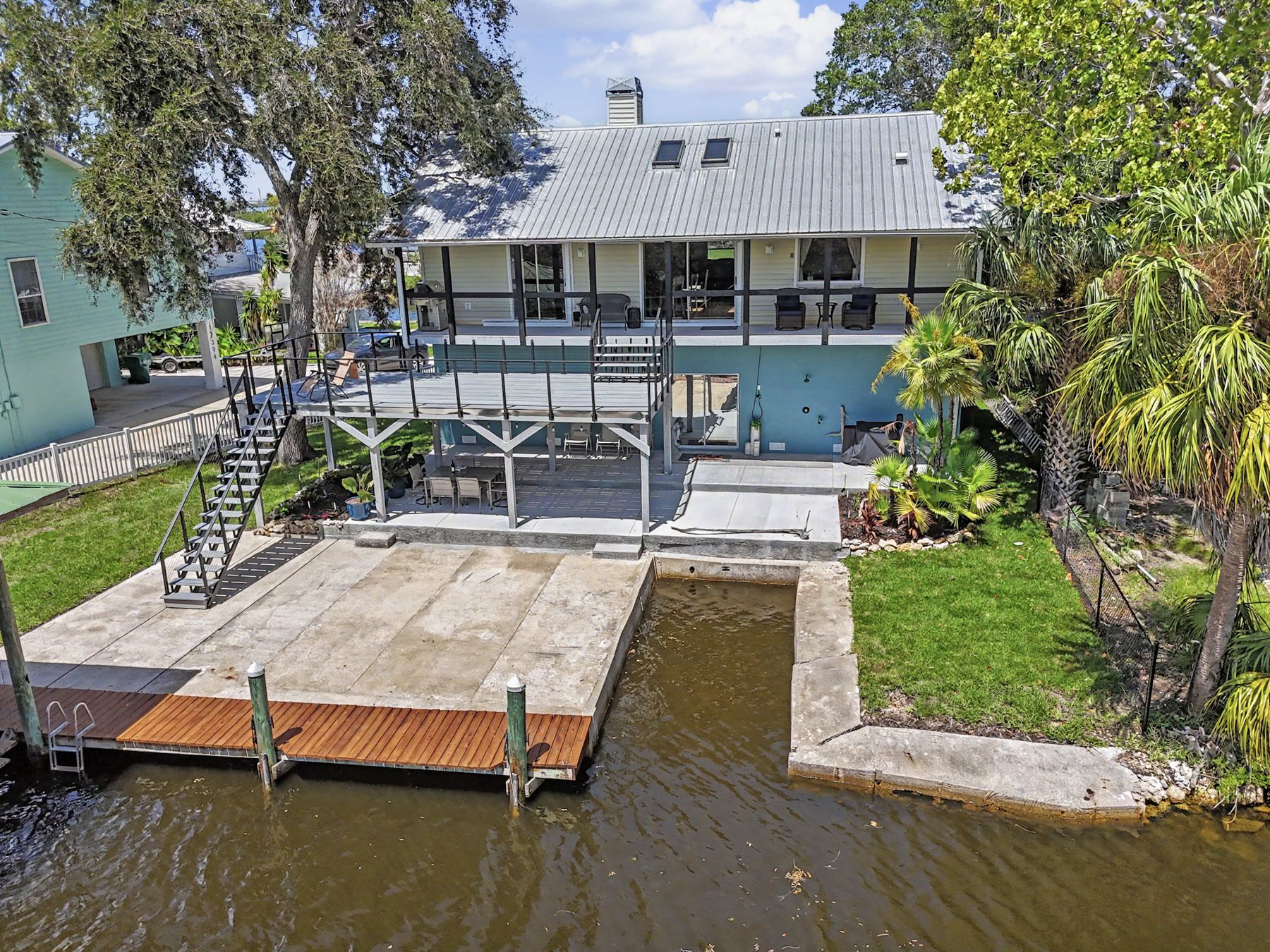 The private dock and the covered lift from above at The Rusty Hook Riverhouse, Old Homosassa, Florida