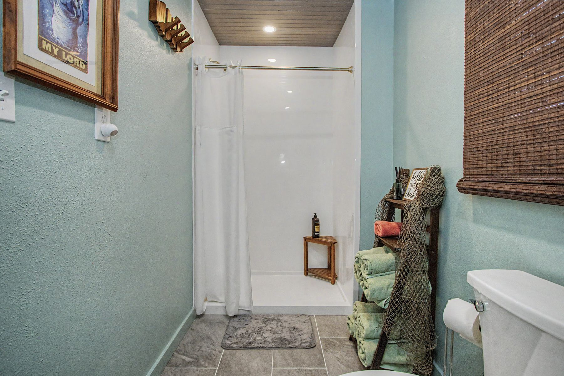 The downstairs bathroom in soft aqua at The Rusty Hook Riverhouse, Old Homosassa, Florida