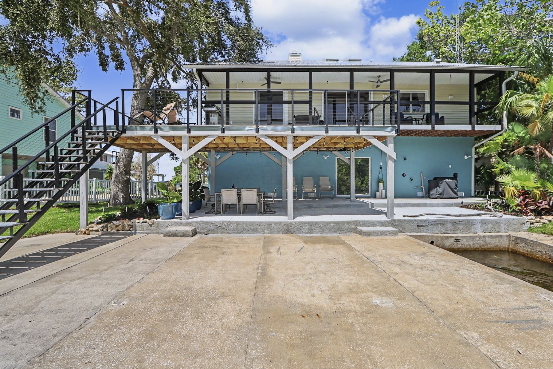 The back of the house from the concrete apron at The Rusty Hook Riverhouse, Old Homosassa, Florida