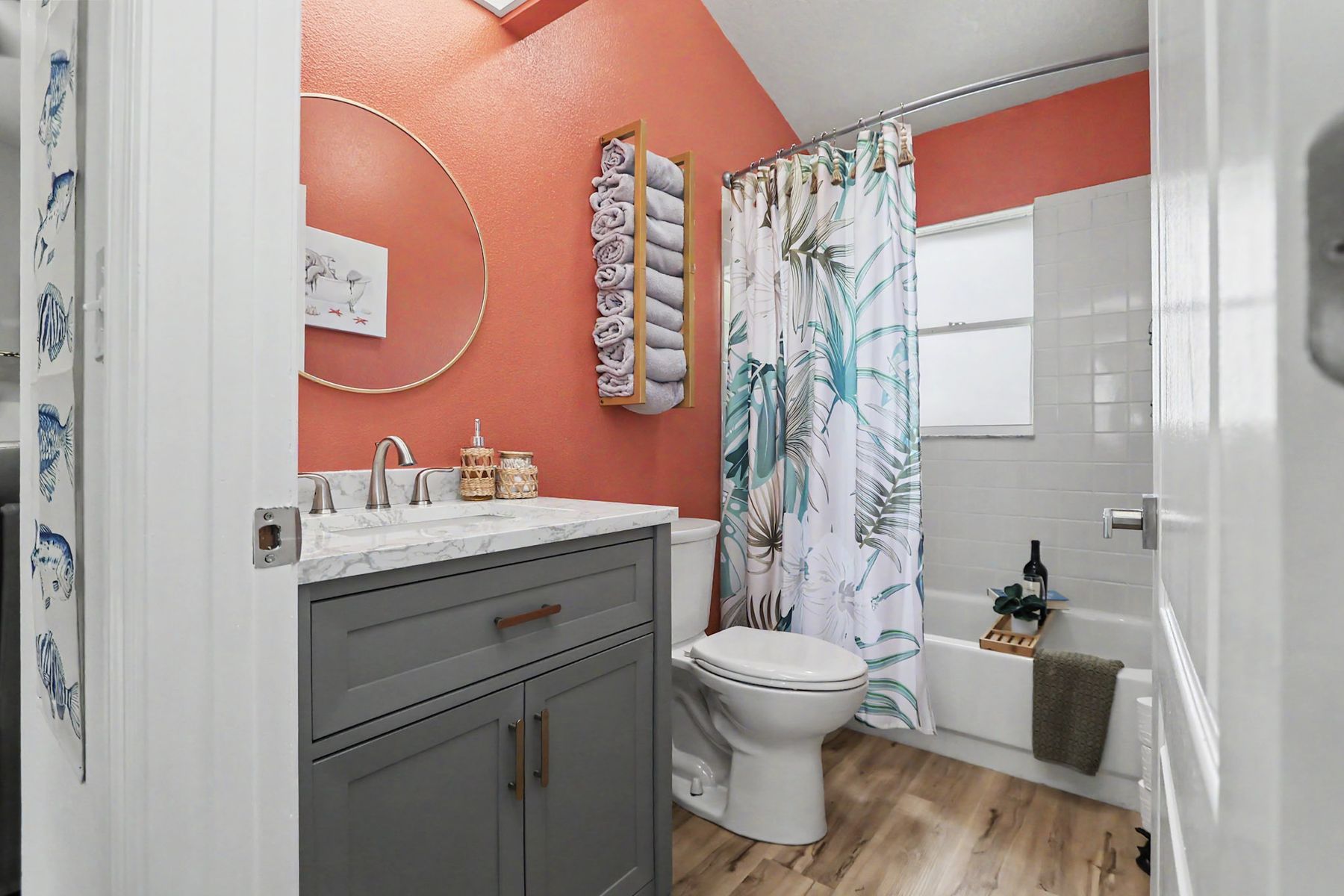 Coral walls, palm-print curtain, marble vanity at The Rusty Hook Riverhouse, Old Homosassa, Florida