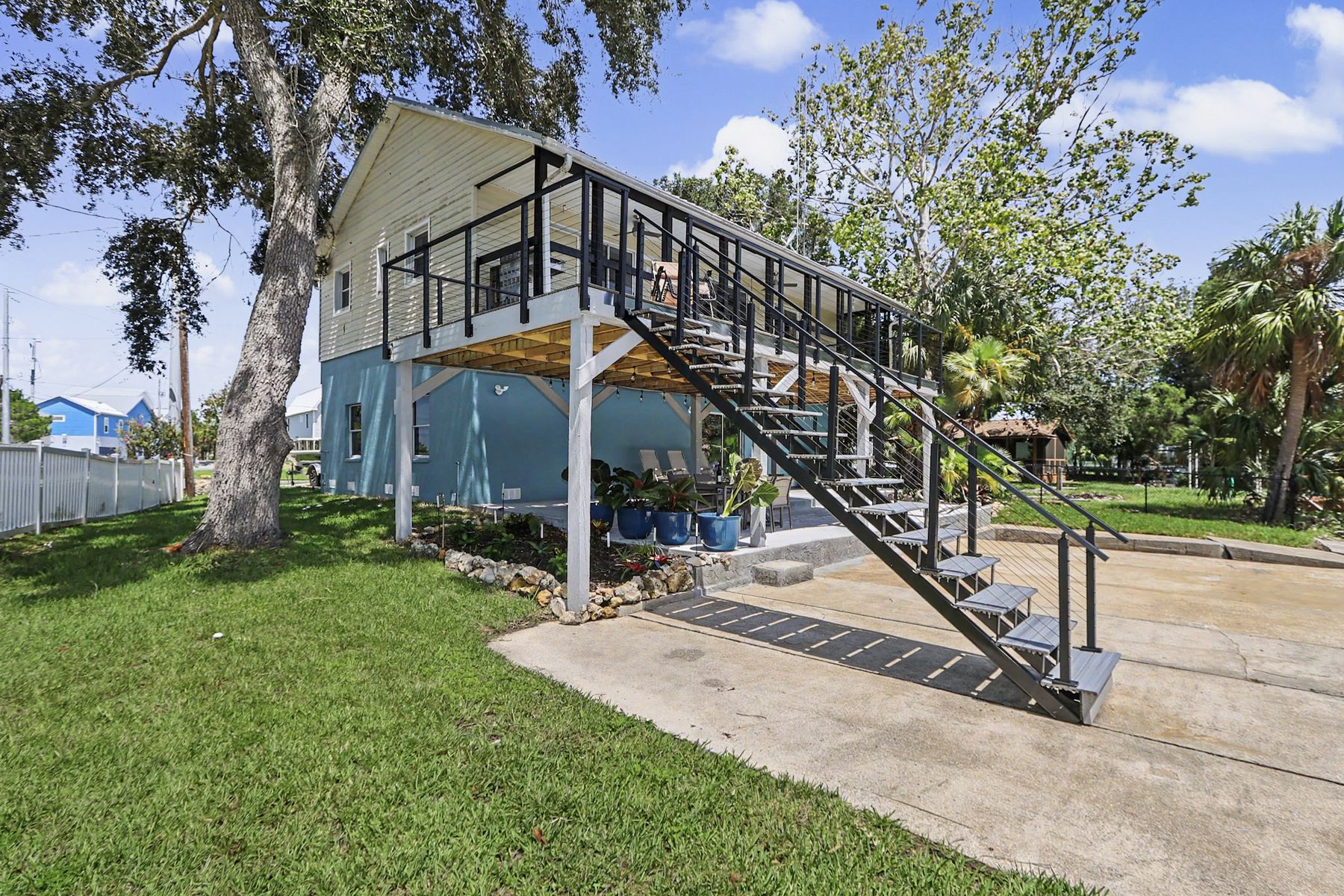The stair to the front door, under the oaks at The Rusty Hook Riverhouse, Old Homosassa, Florida
