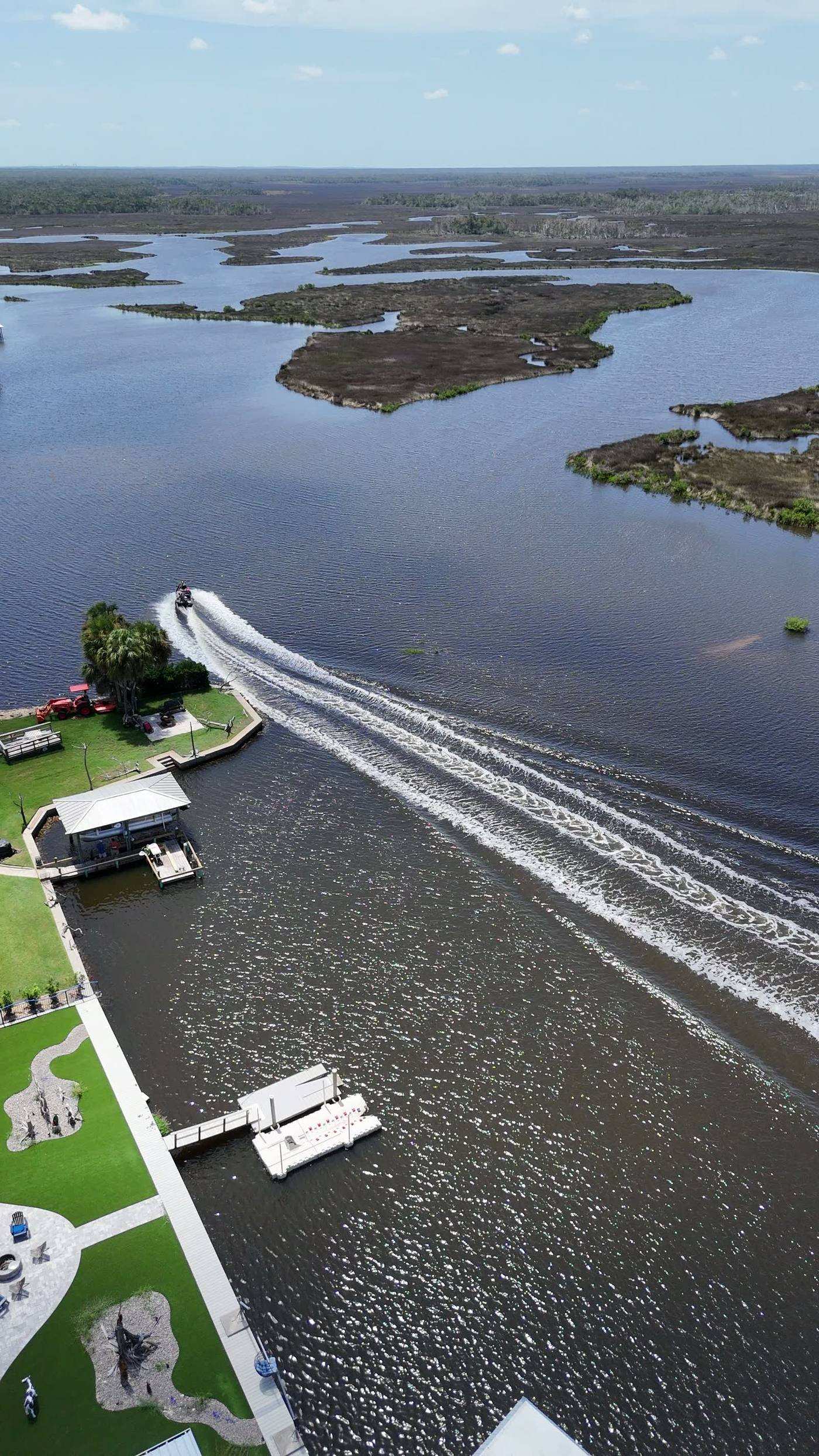 Aerial view over the open water and salt marsh of Mason Creek, Old Homosassa