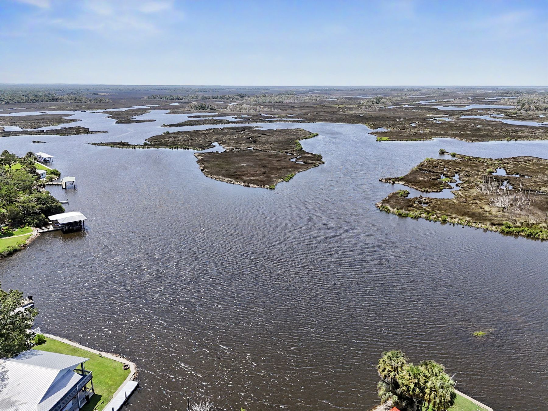 Marsh islands and open water beyond the creek mouth at The Rusty Hook Riverhouse, Old Homosassa, Florida