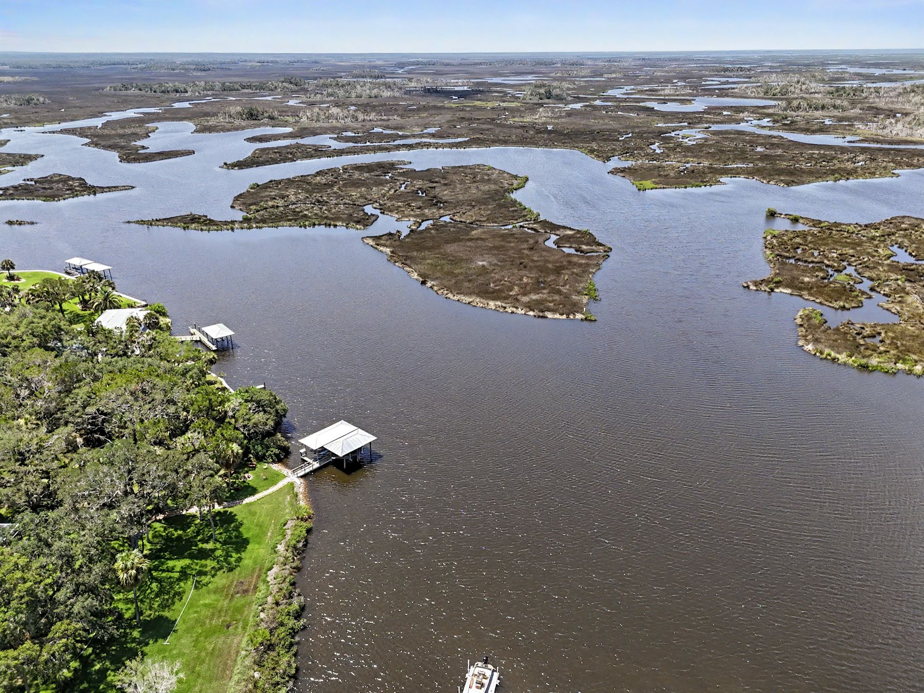 The flats at low water — grass, oyster bar, channel at The Rusty Hook Riverhouse, Old Homosassa, Florida