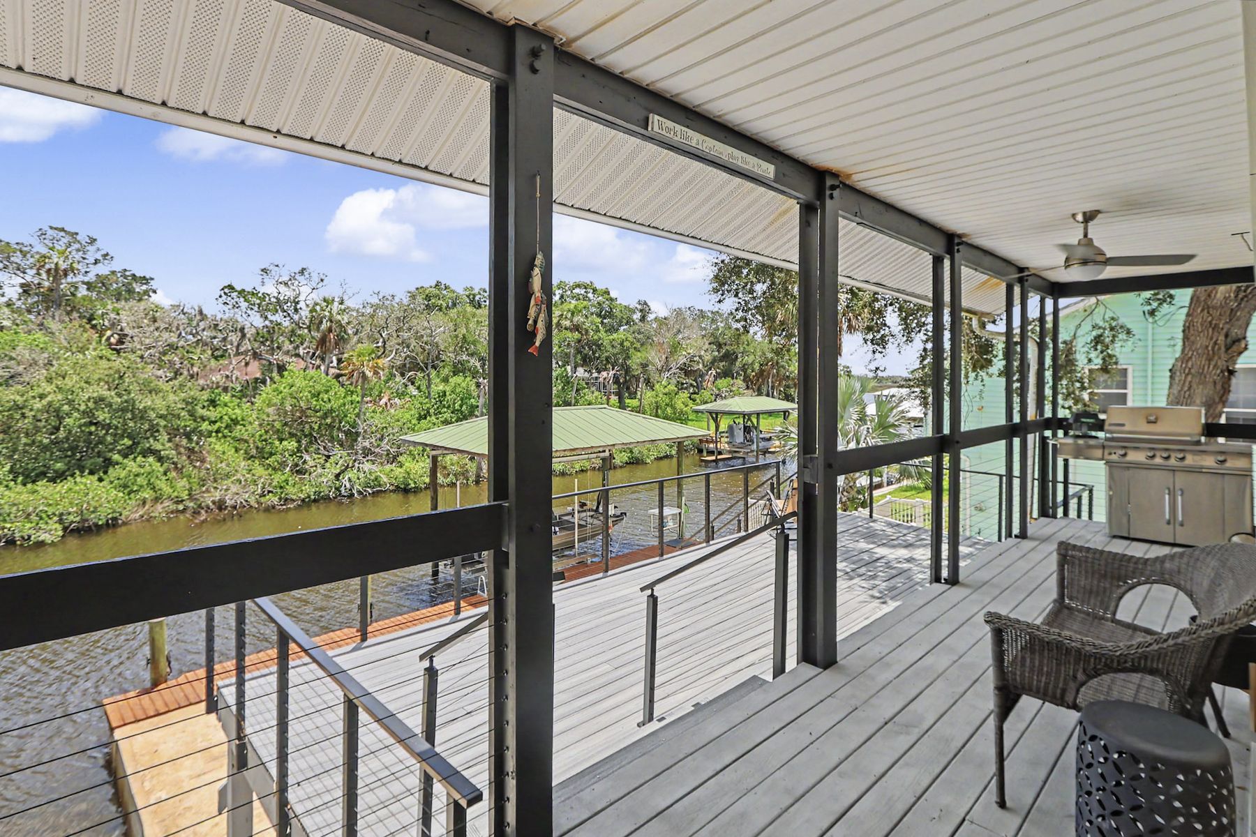 The porch running the length of the house at The Rusty Hook Riverhouse, Old Homosassa, Florida