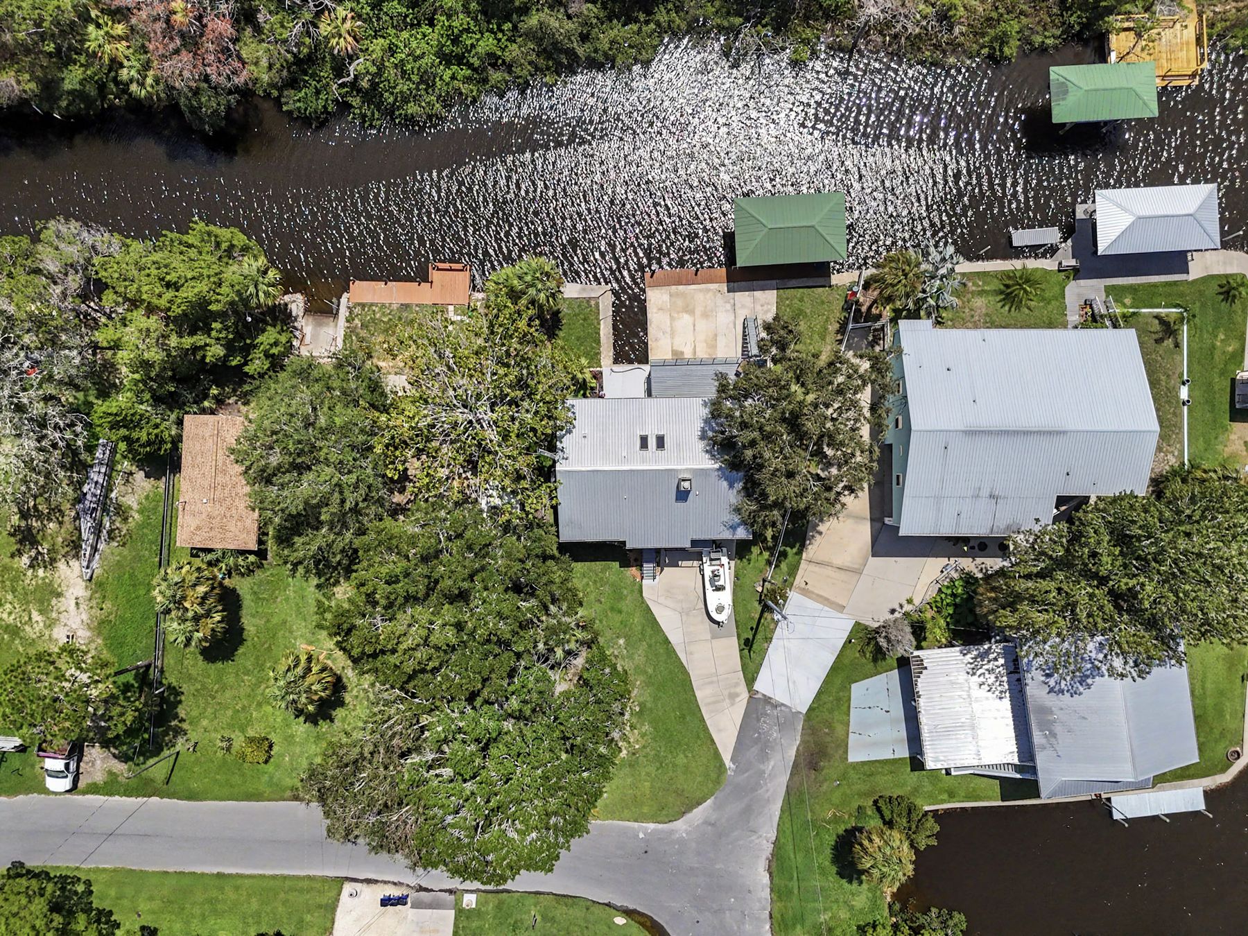 Tree canopy and metal roofs from directly above at The Rusty Hook Riverhouse, Old Homosassa, Florida